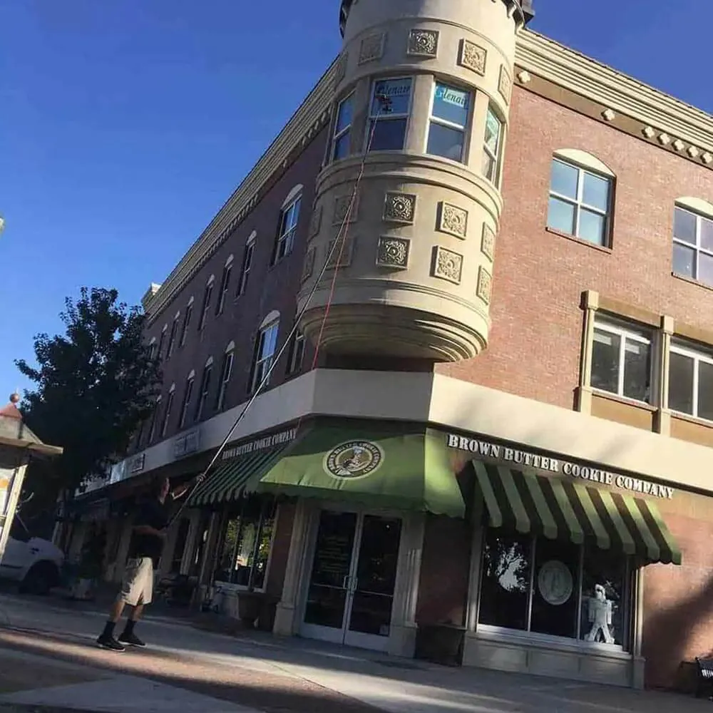 Historic downtown corner building with a clock tower and clean upper windows