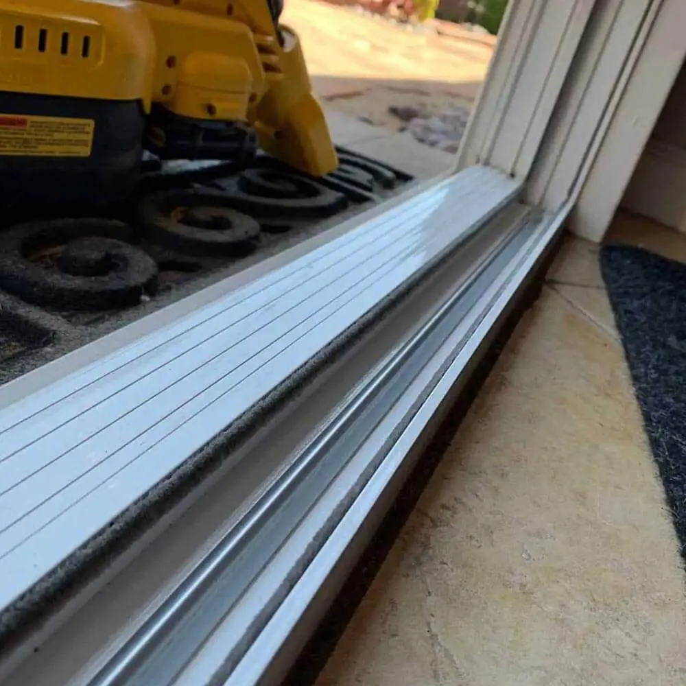 Gutter cleaning tool resting on a cleared gutter run