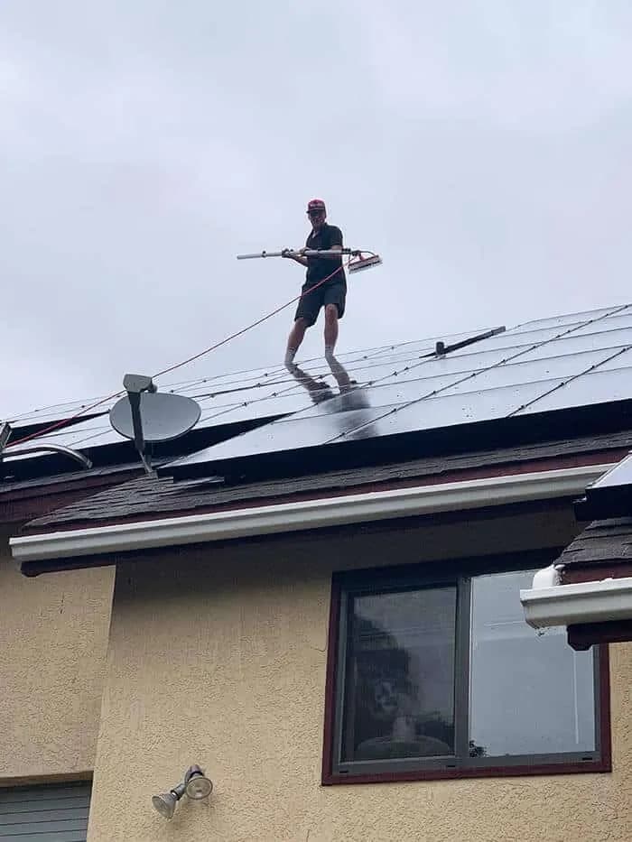 Working on roof mounted solar panels on a residential home