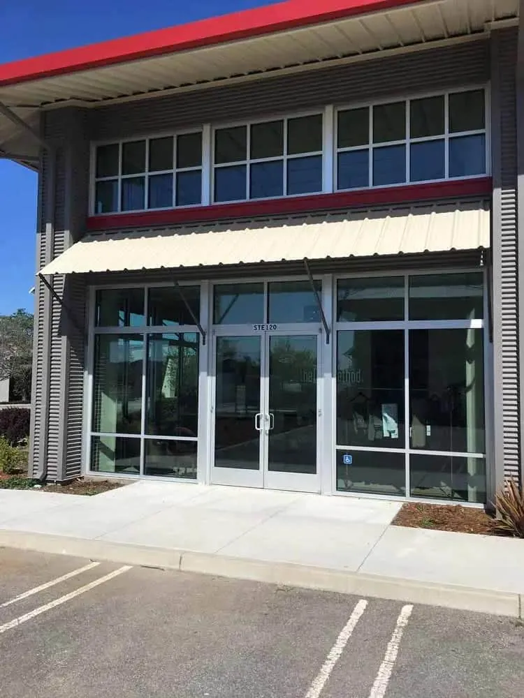 Commercial storefront with an awning and clean full height glass