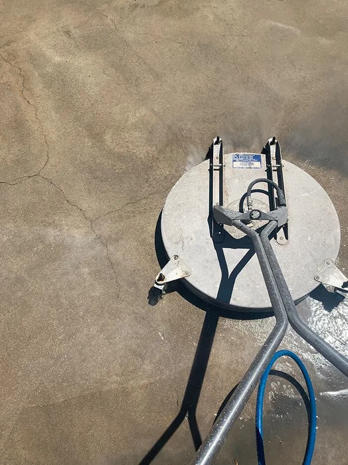 Surface cleaner attachment sitting on wet concrete mid job